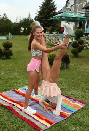 Young lesbians Eveline Dellai & Katy Rose fist pussies during sex on a lawn on shefanatics.com