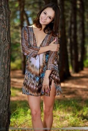 Sweet teen with an ass to die for disrobes for great nude poses in a forest on shefanatics.com