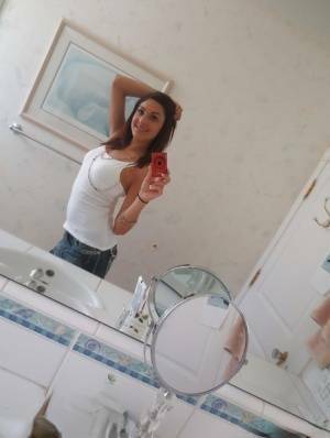 Nasty brunette slut Nikka taking couple of selfies in the bathroom on shefanatics.com