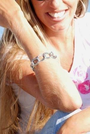 Amateur model Lori Anderson shows off her hairy arms while fully clothed on shefanatics.com