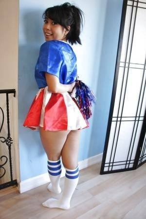 Tiny Asian cheerleader May Lee posing in cute uniform and socks on shefanatics.com