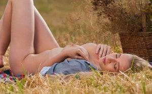 Blonde teen Penelope G displays her great body in a freshly cut farmer's field on shefanatics.com