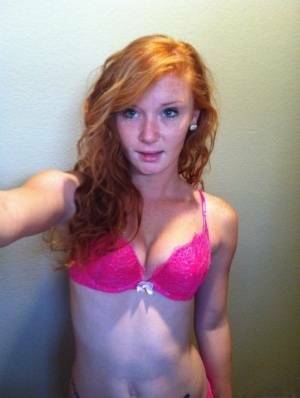 Natural redhead Alex Tanner slips off her pink lingerie set for nude selfies on shefanatics.com