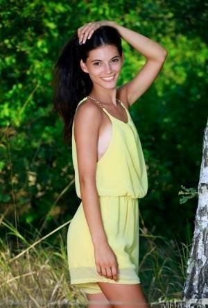 Nice teen Aleksandrina exposes her tan lined body by a hardwood tree on shefanatics.com