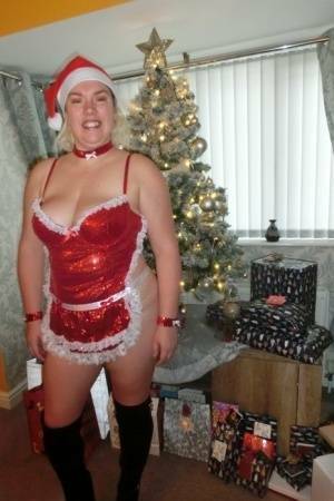 Busty blonde Barby masturbates her shaved pussy near the Christmas tree on shefanatics.com