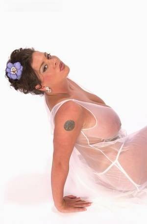 Buxom Linsey Dawn poses to flaunt her droopy tatas in sheer lingerie on shefanatics.com