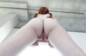 Young redhead Dolly Little revealing shaved pussy in pigtails and socks on shefanatics.com