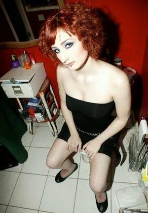 Pale redhead Violet Monroe gets naked in flat shoes while in a bathroom on shefanatics.com