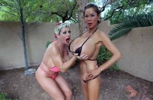 Big titted older women Claudia Marie and Minka kiss outdoors in skimpy bikinis on shefanatics.com