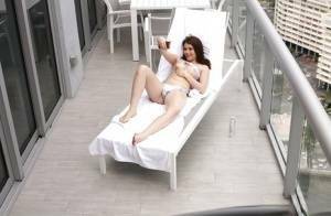 Brunette teen Kylie Quinn caught masturbating on balcony by voyeur on shefanatics.com