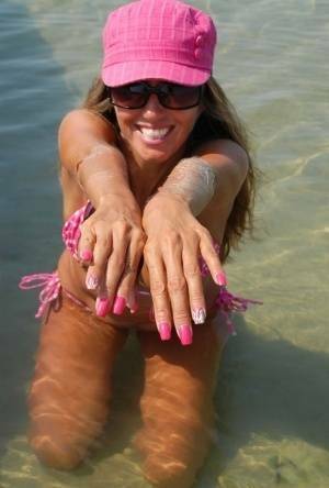Amateur model Lori Anderson shows her hairy arms while wearing a bikini on shefanatics.com