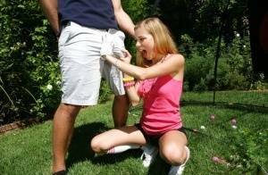 Young blonde girl Nicole Ray giving large dick oral sex outdoors on lawn on shefanatics.com