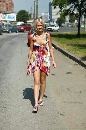 Charming teen blonde posing solo in a lovesome dress outdoor on shefanatics.com