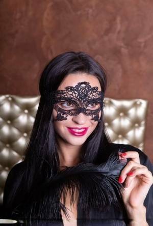 Sexy brunette Leyla Lee removes a mask and robes to pose nude with a feather on shefanatics.com