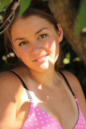 Petite amateur Allie Haze shows her tan lined body in the shade of a tree on shefanatics.com