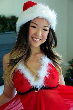 Cute Asian teen Lulu Chu wears Xmas lingerie during sex on a bed on shefanatics.com