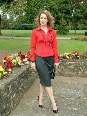 Fully clothed woman steps out of a stiletto heel while visiting a public park on shefanatics.com