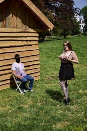 Natural redhead masturbates on a lawn before teasing a masked man on shefanatics.com