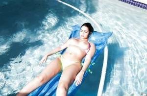 Brunette babe model Ada S going topless on air mattress in swimming pool on shefanatics.com