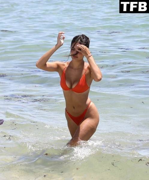 Tao Wickrath Stuns in Small Orange Bikini on the Beach in Miami on shefanatics.com