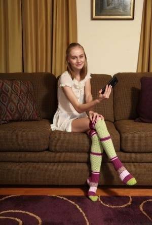 Adorable teen Alicia Williams takes a selfie before getting naked in OTK socks on shefanatics.com