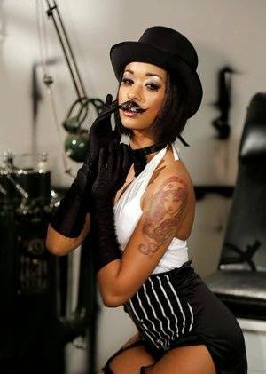 Ebony pornstar Skin Diamond strutting in vintage hat and long gloves on shefanatics.com