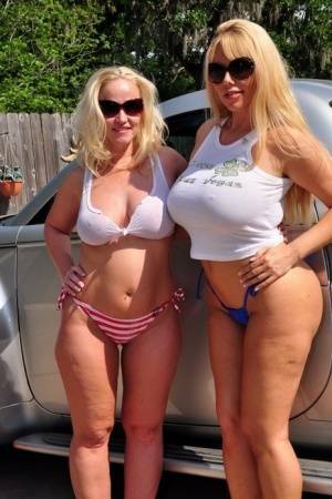 Busty blonde Dee Siren and her big titted girlfriend get fucked in a driveway on shefanatics.com