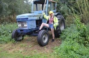 Mature amateur Barby Slut exposes herself on heavy equipment at a job site on shefanatics.com