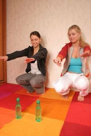 Young blonde uncovers her big tits while stretching out next to a girlfriend on shefanatics.com