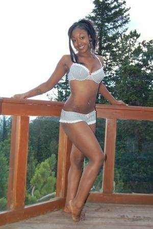 Black girl Amber uncups her big tits while getting in an outdoor hot tub on shefanatics.com