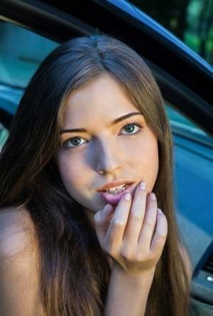 Beautiful teen girl models in the nude on passenger seat of car with door open on shefanatics.com